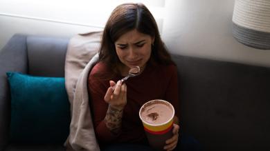 
		Woman eats crying ice cream against grief
	